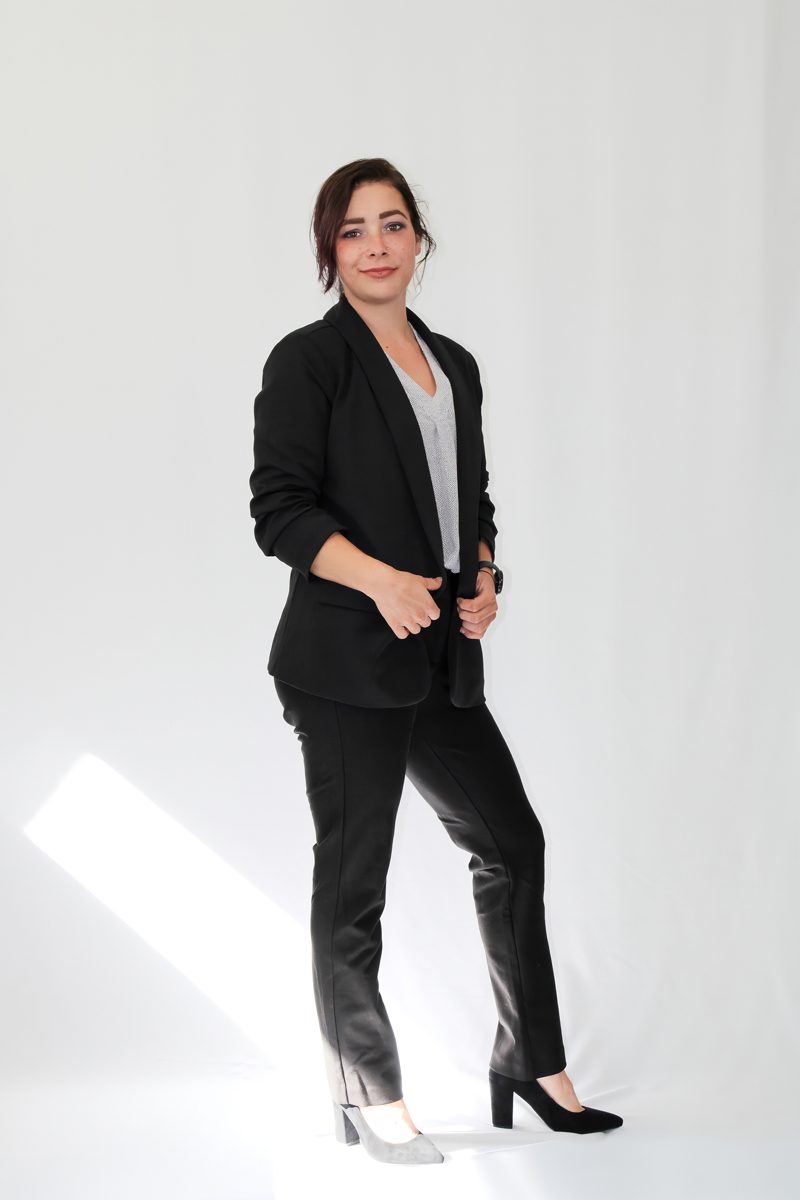 Jordan Johnston standing in a black suit